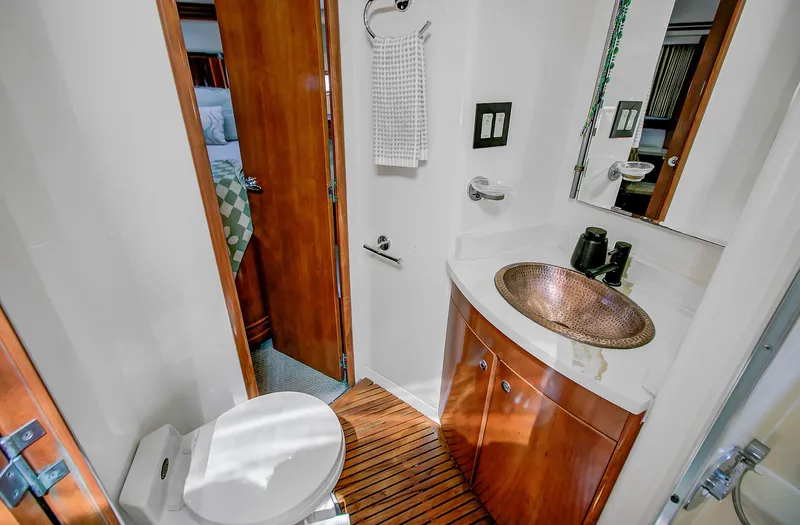 No Surrender Yacht Photos Pics Luxurious bathroom in 2000 Carver 530 Voyager Pilothouse with copper sink and wooden accents.