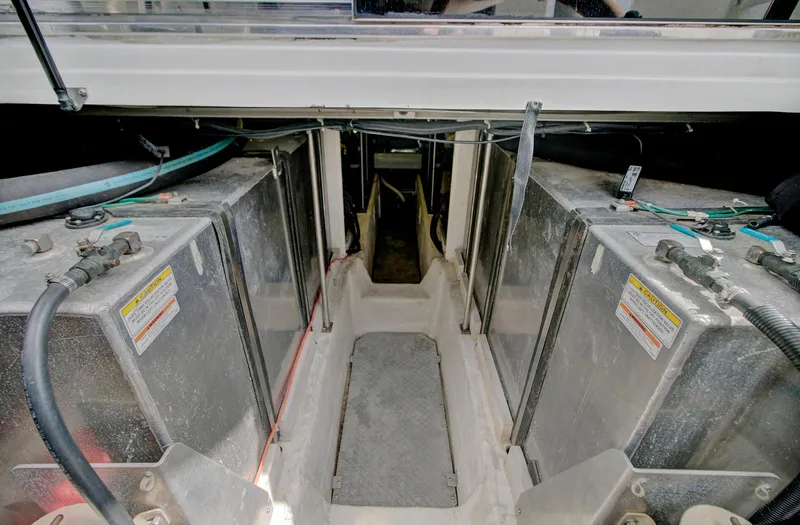 No Surrender Yacht Photos Pics Engine compartment of 2000 Carver 530 Voyager Pilothouse with visible fuel tanks and wiring.