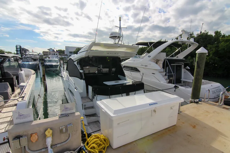  Yacht Photos Pics Docked 2021 Galeon 425 HTS yacht under a partly cloudy sky.