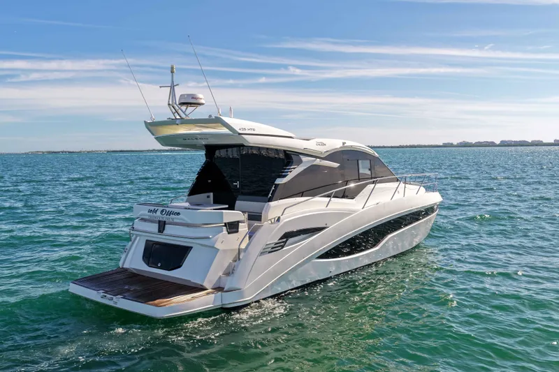  Yacht Photos Pics 2021 Galeon 425 HTS yacht cruising on open water under a clear blue sky.