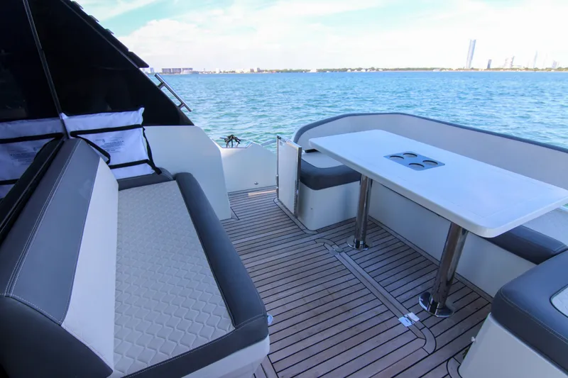 Yacht Photos Pics Luxury deck of 2021 Galeon 425 HTS yacht with seating and table, overlooking the ocean.