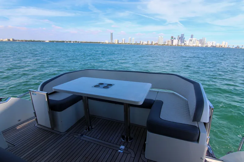  Yacht Photos Pics Luxury seating area on 2021 Galeon 425 HTS yacht with city skyline view.