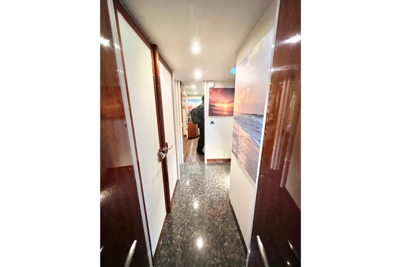  Yacht Photos Pics Hallway inside 2007 Lazzara 68 yacht with glossy floors and sunset artwork.