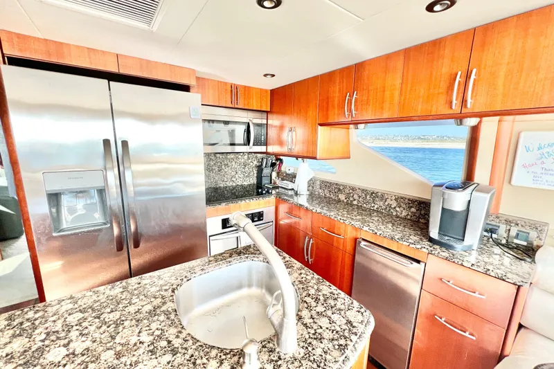  Yacht Photos Pics Luxurious kitchen interior of 2007 Lazzara 68 yacht with granite countertops and stainless steel appliances.