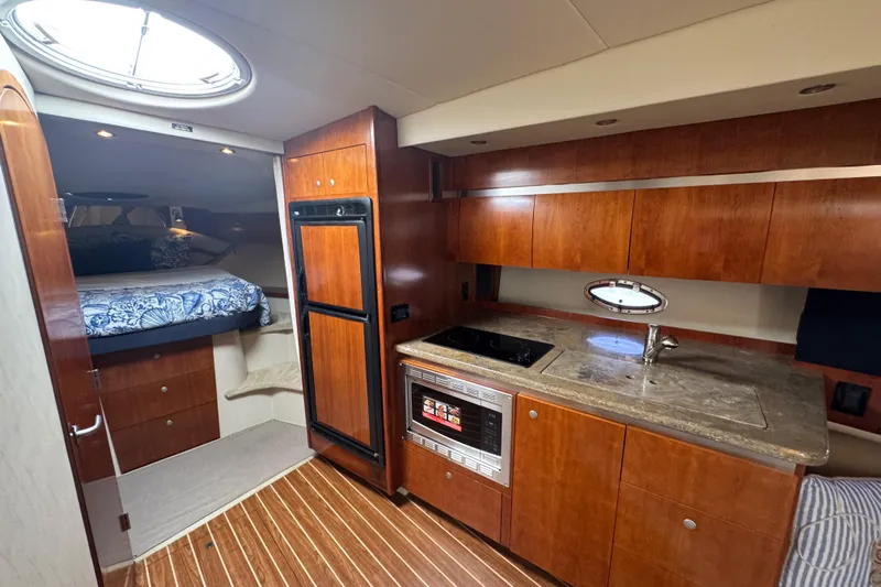  Yacht Photos Pics Luxurious 2008 Cruisers 420 yacht interior with kitchenette and cozy sleeping area.