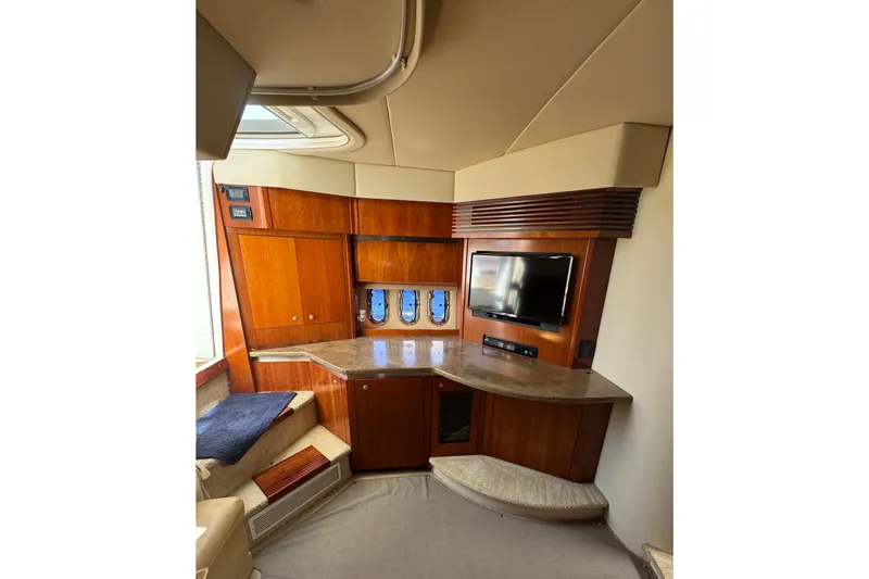  Yacht Photos Pics Interior of 2008 Cruisers 420 yacht with wood cabinetry and mounted TV.
