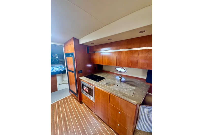  Yacht Photos Pics Luxurious 2008 Cruisers 420 yacht interior with modern kitchen and wood cabinetry.