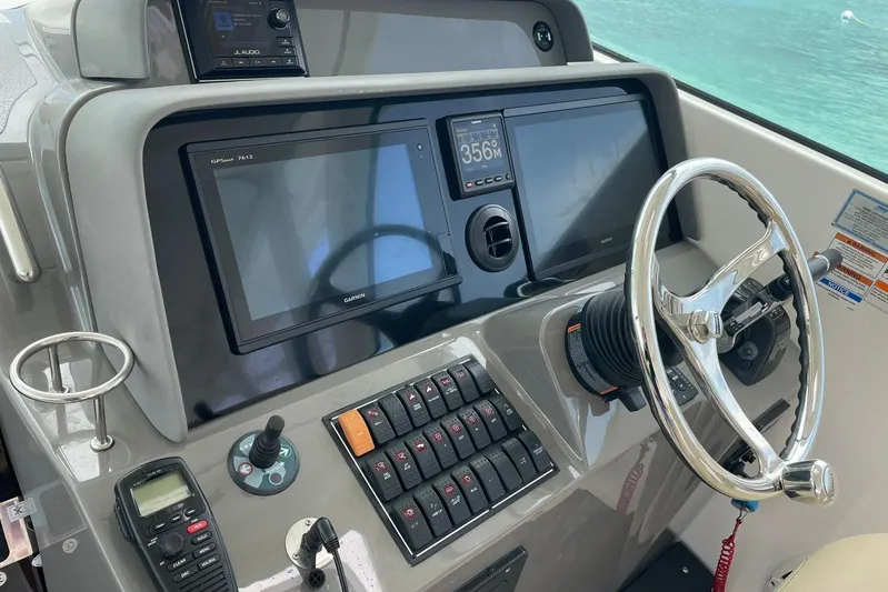  Yacht Photos Pics Helm of 2018 Pursuit OS 385 Offshore boat with Garmin navigation system and steering wheel.