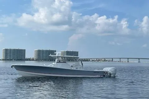  Yacht Photos Pics 2020 Regulator 41 boat on calm water with cityscape and bridge in background.