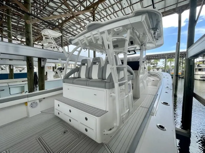  Yacht Photos Pics 2020 Regulator 41 boat with seating and storage, docked in a covered marina.