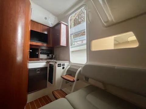  Yacht Photos Pics Interior of a 2020 Regulator 41 boat with kitchenette and seating area.
