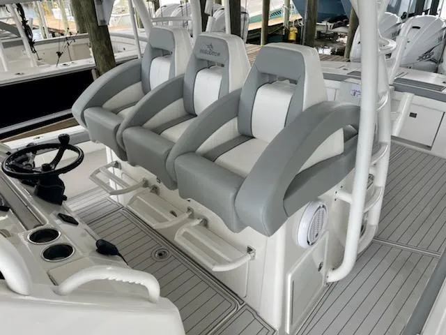  Yacht Photos Pics 2020 Regulator 41 boat with three cushioned helm seats and steering console.