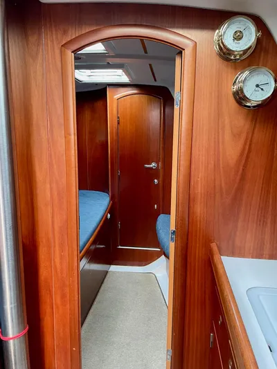Oasis Yacht Photos Pics Interior of 2004 Beneteau Oceanis 393 sailboat with wood finish and cozy cabin.