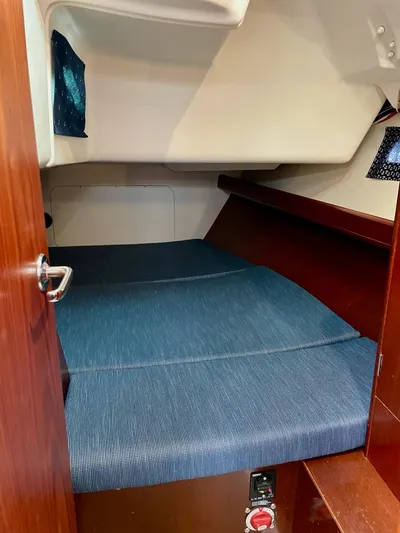 Oasis Yacht Photos Pics Beneteau Oceanis 393 cabin interior with blue bedding, 2004 model.