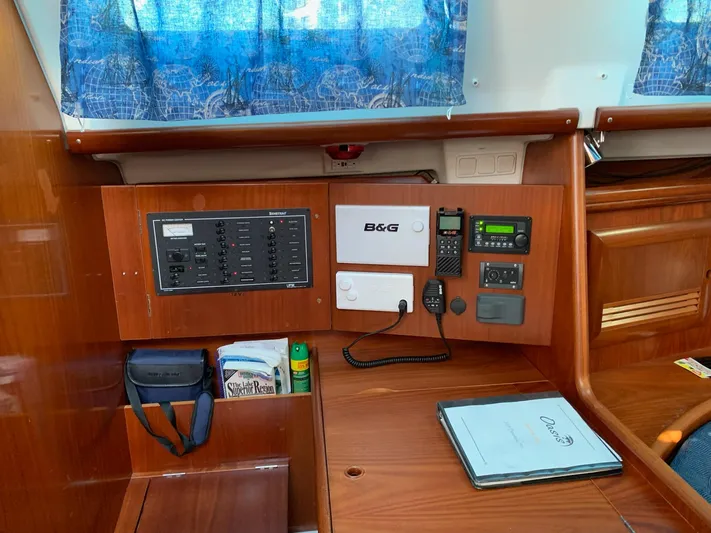 Oasis Yacht Photos Pics Navigation station of 2004 Beneteau Oceanis 393 with control panel and communication equipment.