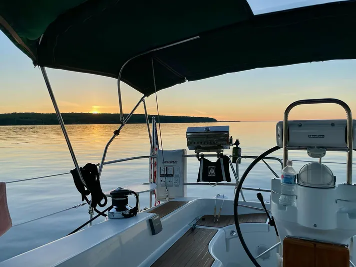 Oasis Yacht Photos Pics 2004 Beneteau Oceanis 393 sailboat at sunset on calm waters.