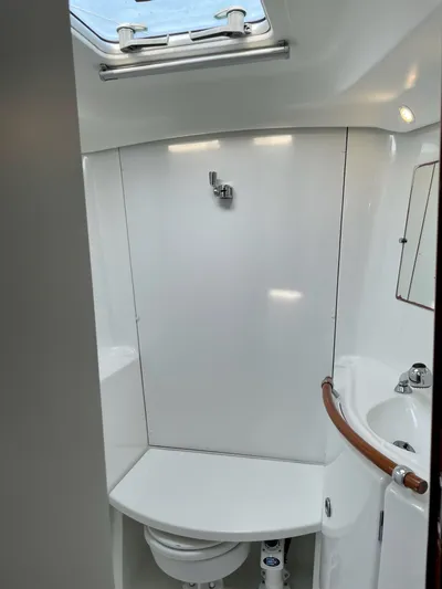 Oasis Yacht Photos Pics Bathroom interior of 2004 Beneteau Oceanis 393 yacht, featuring modern fixtures and skylight.