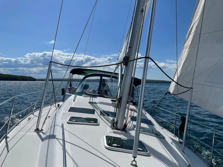 Oasis Yacht Photos Pics 2004 Beneteau Oceanis 393 sailing on open water under clear blue skies.