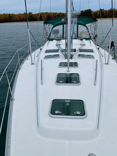 Oasis Yacht Photos Pics 2004 Beneteau Oceanis 393 sailboat on calm water, showcasing deck and hatches.