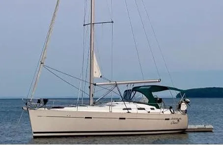 Oasis Yacht Photos Pics 2004 Beneteau Oceanis 393 sailboat anchored on calm water with green canopy.