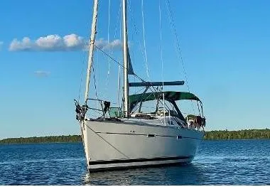 Oasis Yacht Photos Pics 2004 Beneteau Oceanis 393 sailboat on calm water under a clear blue sky.