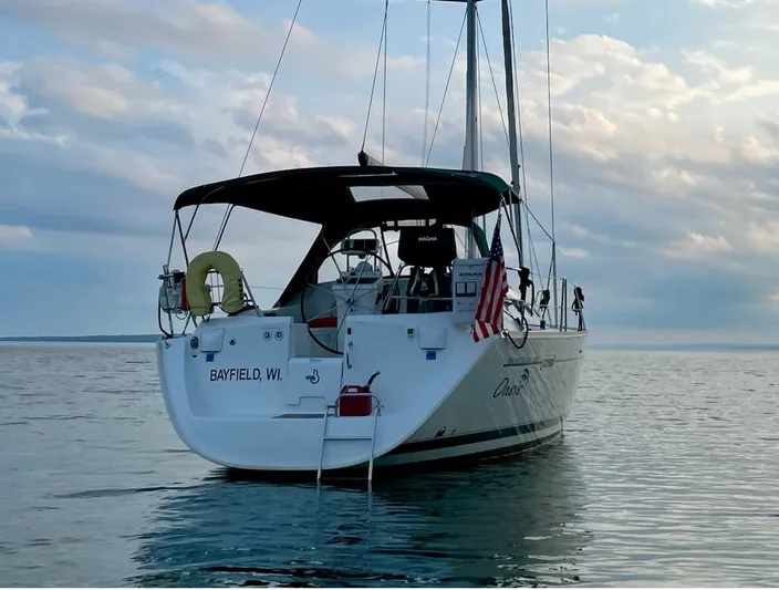 Oasis Yacht Photos Pics 2004 Beneteau Oceanis 393 sailboat anchored on calm water, Bayfield, WI.