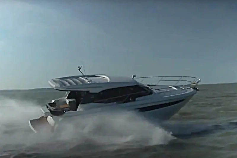 #boatshowspecial Yacht Photos Pics 2023 Bavaria R40 Coupe cruising swiftly on open water.