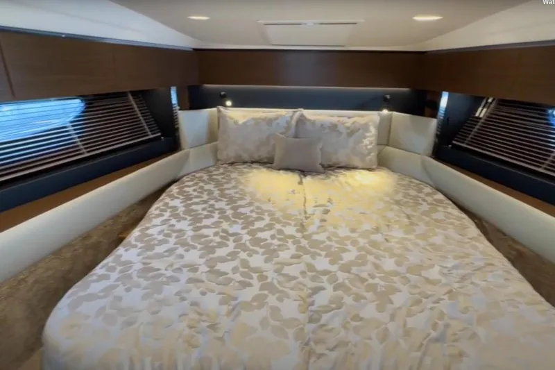 #boatshowspecial Yacht Photos Pics Luxurious bedroom interior of 2023 Bavaria R40 Coupe yacht with elegant bedding and wood accents.