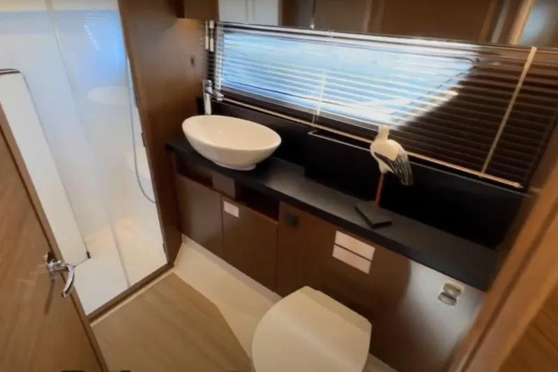 #boatshowspecial Yacht Photos Pics Luxurious bathroom interior of 2023 Bavaria R40 Coupe yacht with modern fixtures.
