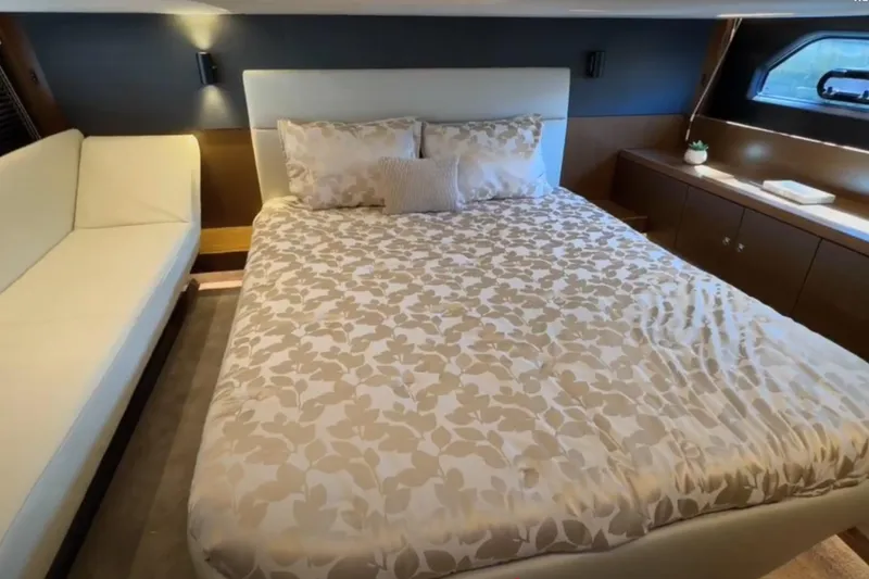 #boatshowspecial Yacht Photos Pics Luxurious bedroom interior of 2023 Bavaria R40 Coupe yacht with elegant bedding and modern design.