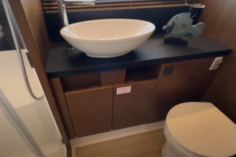#boatshowspecial Yacht Photos Pics Luxurious bathroom in 2023 Bavaria R40 Coupe yacht with modern sink and decor.
