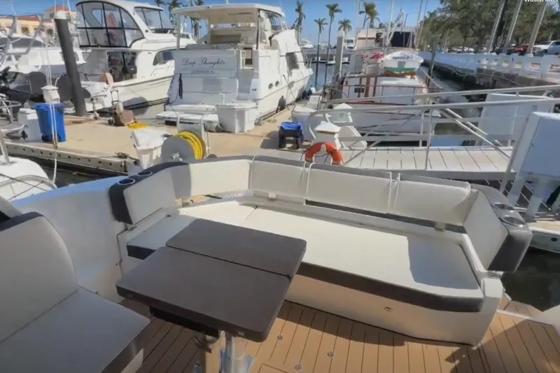 #boatshowspecial Yacht Photos Pics 2023 Bavaria R40 Coupe yacht interior with seating and table at marina.