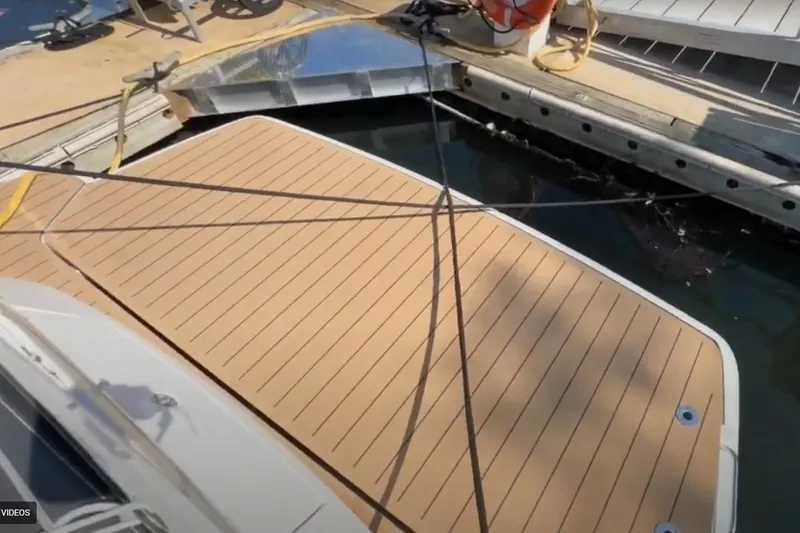 #boatshowspecial Yacht Photos Pics 2023 Bavaria R40 Coupe yacht docked with wooden deck and mooring lines.