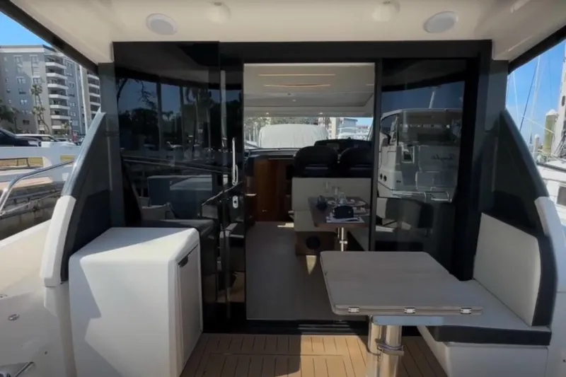 #boatshowspecial Yacht Photos Pics 2023 Bavaria R40 Coupe yacht interior with modern seating and table setup.