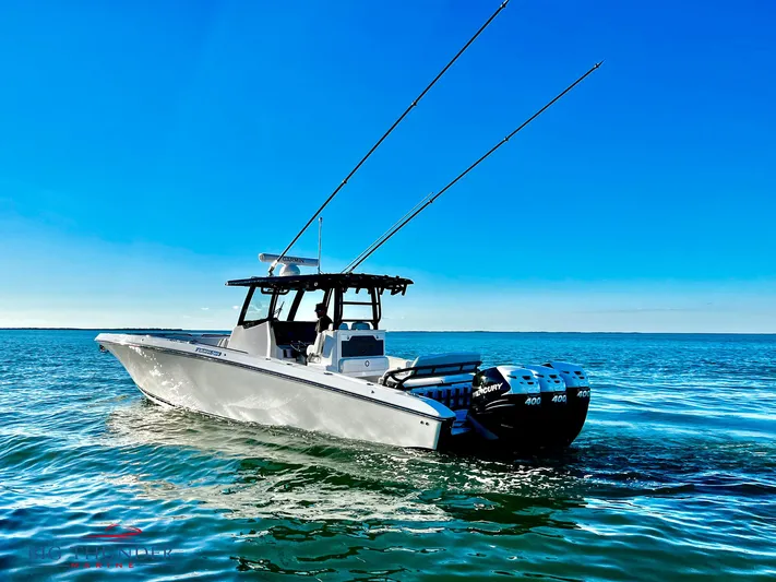  Yacht Photos Pics 2023 Fountain 38 TE boat on open water with fishing rods.