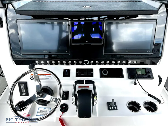  Yacht Photos Pics 2023 Fountain 38 TE boat dashboard with dual Garmin displays and steering wheel.