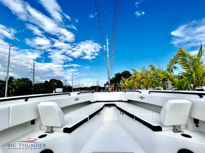  Yacht Photos Pics 2023 Fountain 38 TE boat interior with white seating, blue sky background.
