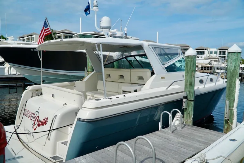 Survey Cruise Yacht Photos Pics 1998 Tiara Yachts 4000 Express docked at marina, featuring sleek design and spacious deck.