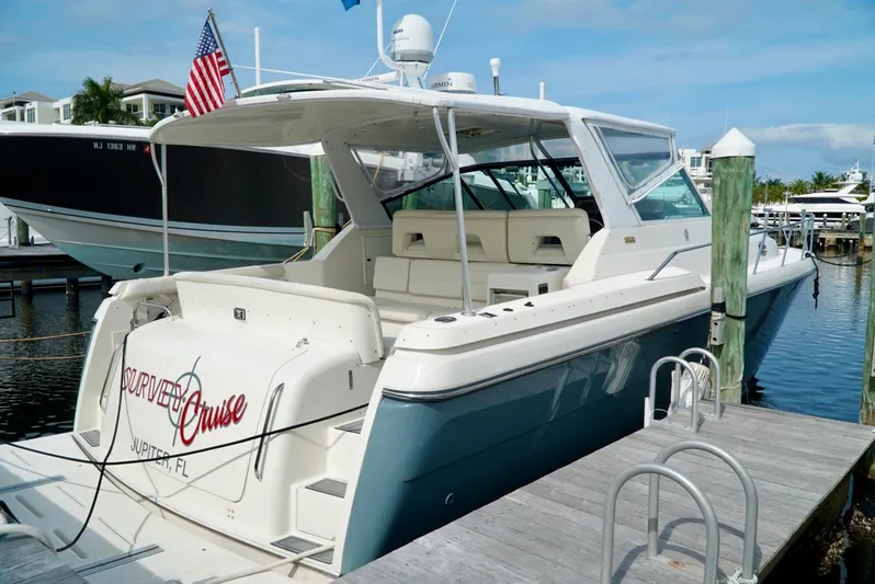 Survey Cruise Yacht Photos Pics 1998 Tiara Yachts 4000 Express docked, featuring spacious seating and sleek design.