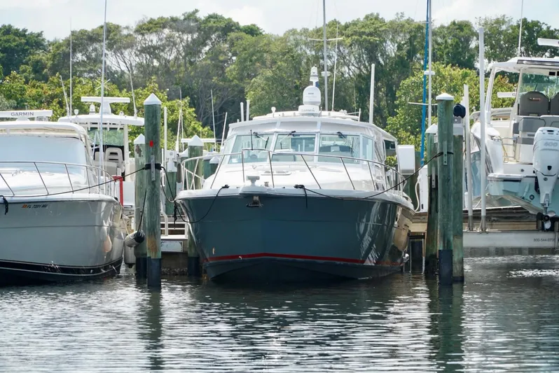 Survey Cruise Yacht Photos Pics 1998 Tiara Yachts 4000 Express docked at marina, surrounded by other boats.