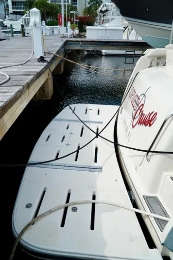 Survey Cruise Yacht Photos Pics 1998 Tiara Yachts 4000 Express docked at marina with swim platform.