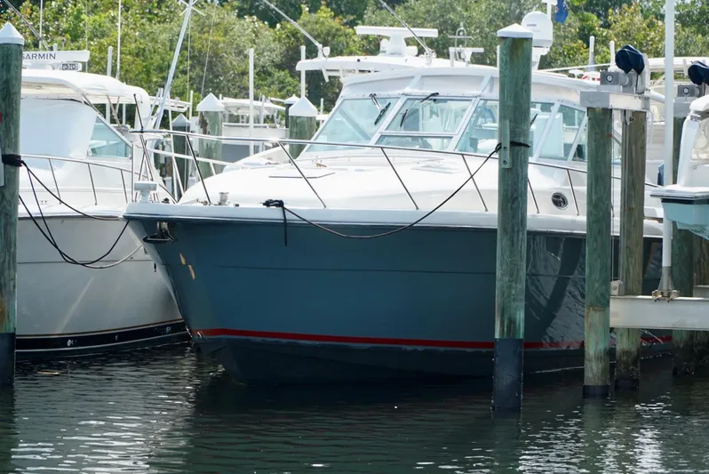 Survey Cruise Yacht Photos Pics 1998 Tiara Yachts 4000 Express docked at marina, surrounded by other boats.