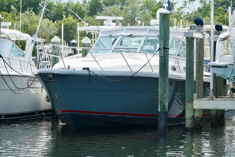 Survey Cruise Yacht Photos Pics 1998 Tiara Yachts 4000 Express docked at marina, surrounded by other boats.