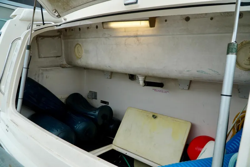 Survey Cruise Yacht Photos Pics 1998 Tiara Yachts 4000 Express storage compartment with various boating equipment and accessories.