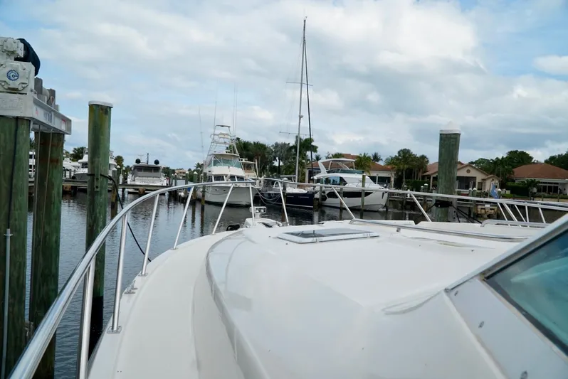 Survey Cruise Yacht Photos Pics 1998 Tiara Yachts 4000 Express docked at a marina under a cloudy sky.