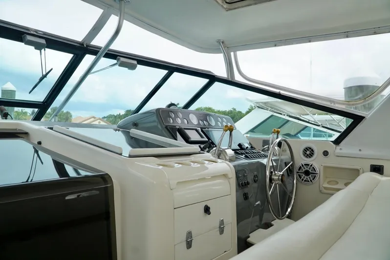 Survey Cruise Yacht Photos Pics Interior view of 1998 Tiara Yachts 4000 Express helm with steering wheel and controls.