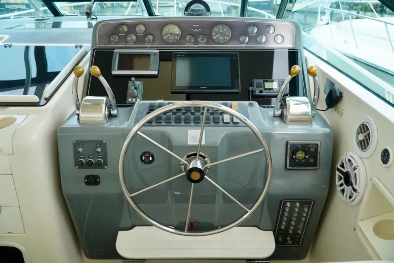Survey Cruise Yacht Photos Pics 1998 Tiara Yachts 4000 Express helm with steering wheel and control panel.