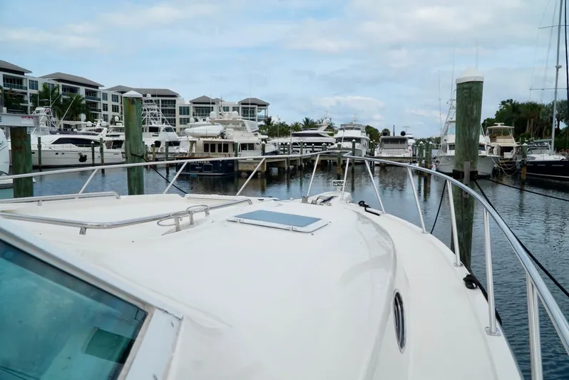 Survey Cruise Yacht Photos Pics 1998 Tiara Yachts 4000 Express docked in a marina with other boats.