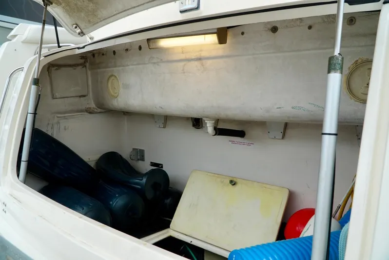 Survey Cruise Yacht Photos Pics Storage compartment of a 1998 Tiara Yachts 4000 Express, featuring various boating equipment.