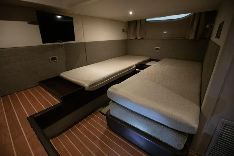 Logan Yacht Photos Pics 2018 Sea Ray Sundancer 400 cabin interior with twin beds and a wall-mounted TV.